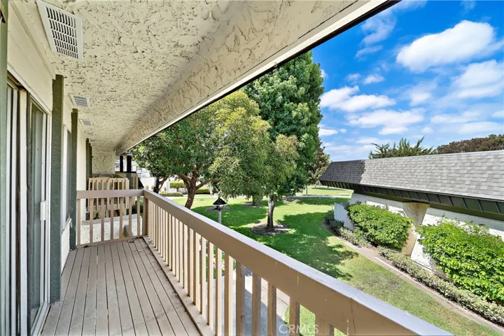 Sliding glass doors open from the Primary Suite to a balcony that over looks the greenbelt and pool