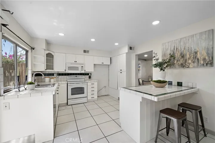 Kitchen has a Breakfast Bar and Recessed Lighting