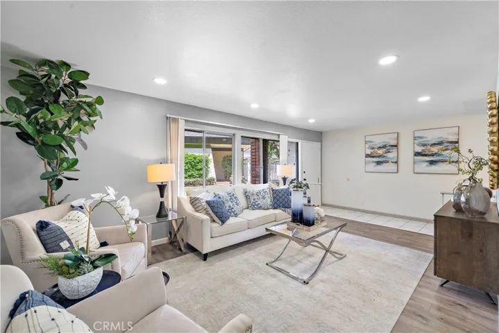 Tiled Entry, Living Room with Wood Laminate Flooring and Recessed Lighting