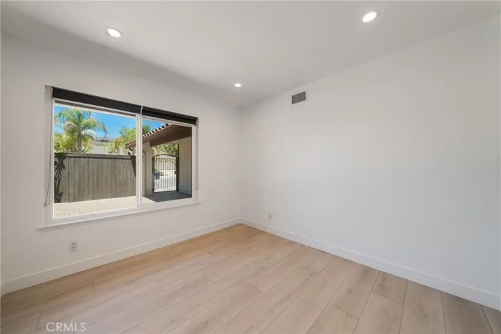 Third bedroom looks to courtyard has nice sized closet ad blinds.