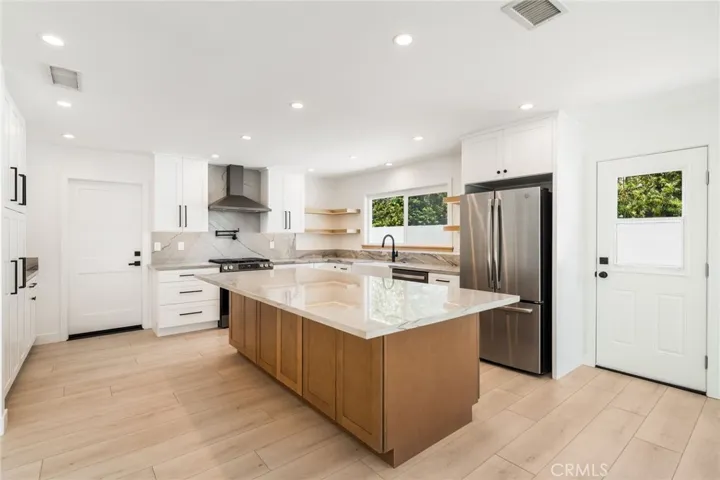 Door on left leads into the two car garage. Lots of seating at the island as well as storage under the island. Door on the right opens to side yard.
