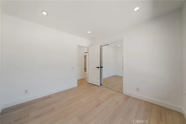 Bedroom with mirrored doors.