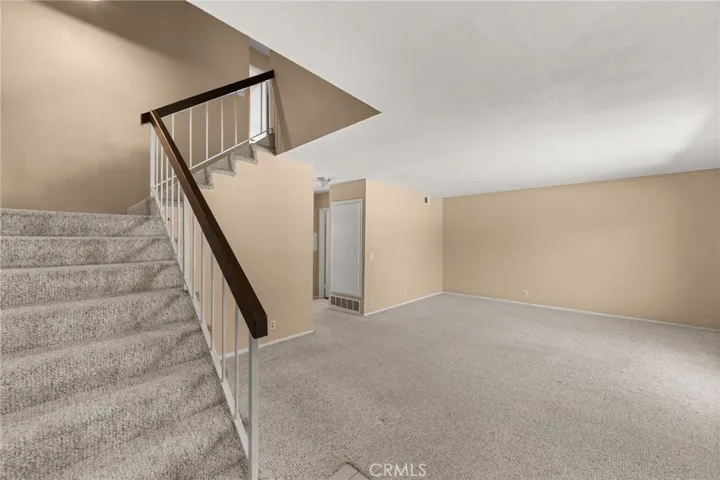 Staircase and spacious living room.
