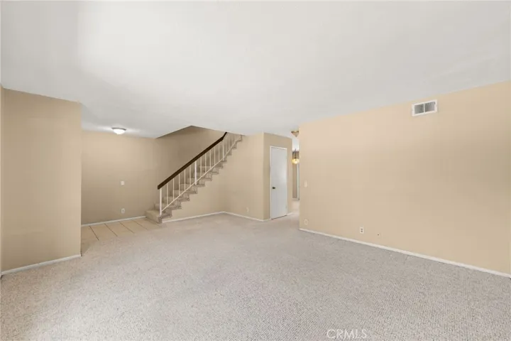 Large living room showing the staircase.