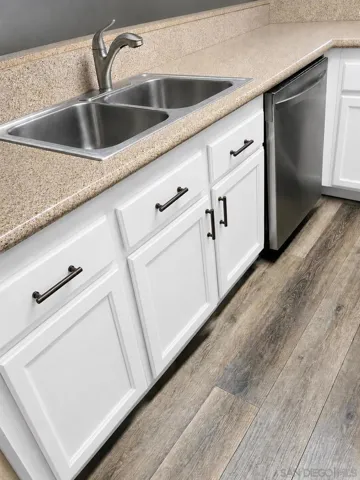 Cabinets are in the process of being refinished, fitted with soft-close hinges and handle pulls - and should look something like this when done