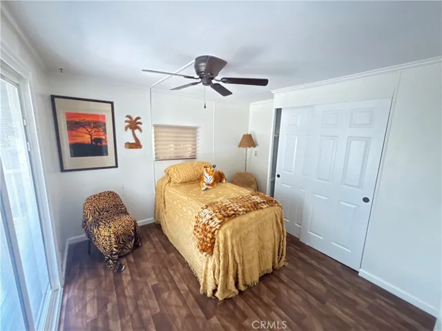 Bedroom with barn door and large sliding door with custom installed blinds in back glass