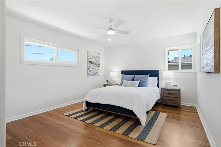 A spacious full sized primary bedroom, featuring a walk-in closet & a 2nd full sized closet & ensuite bathroom.