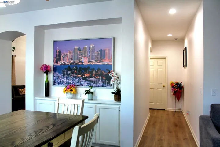 Bright hallway with recessed lighting, built-in cabinetry, and beautiful wood flooring. A clean, functional design provides convenient storage while enhancing the home's open, inviting layout.