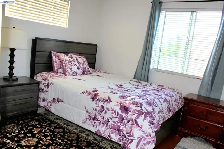 Bright secondary bedroom with abundant natural light, generous closet space, and a comfortable layout. Perfect for family, guests, or a private home office.