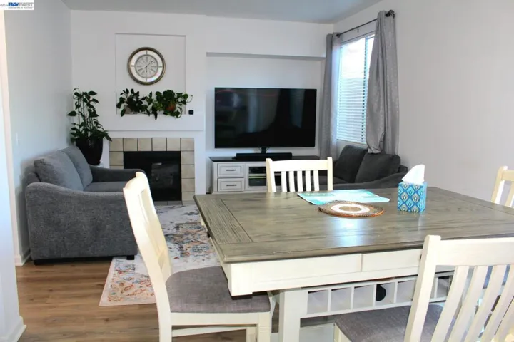 Inviting family room with a cozy fireplace, large window, and open floor plan. A bright and comfortable space designed for everyday living and gathering with family and friends.