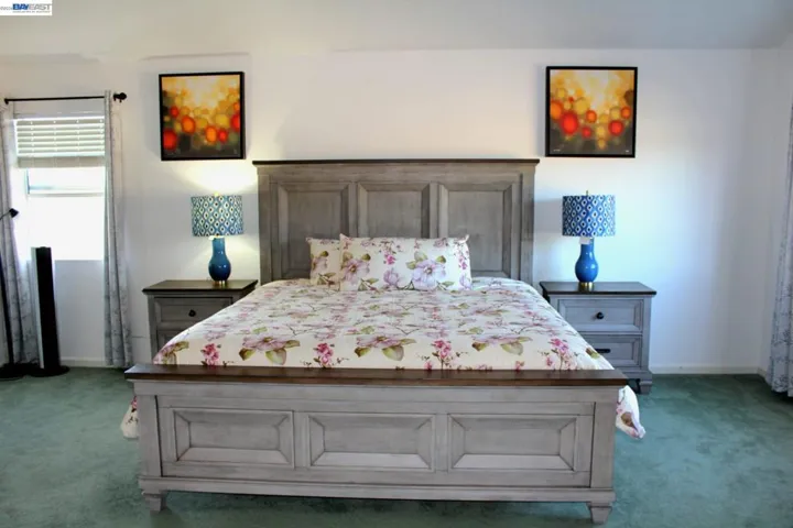 Expansive primary bedroom with generous space, large windows, and a bright, airy feel. A relaxing retreat with plenty of room for a sitting area and your personal touch.