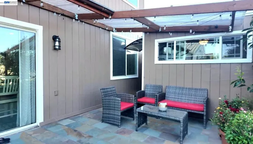 Expansive stone patio overlooks serene open space and rolling hills. A detached bonus studio offers endless possibilities as a private home office, gym, art studio, workshop, or flexible bonus space.