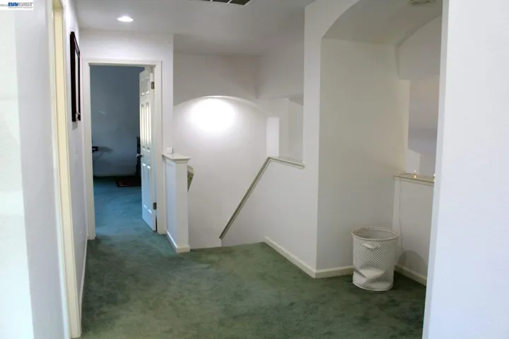 The open upstairs landing adds a sense of space and flow, connecting the bedrooms with elegant architectural details and a bright, welcoming atmosphere.