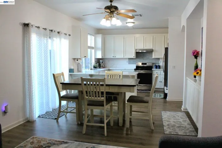 Light-filled dining area with sliding glass doors leading to the backyard, an open-concept layout, and seamless connection to the updated kitchen—perfect for family meals and entertaining.