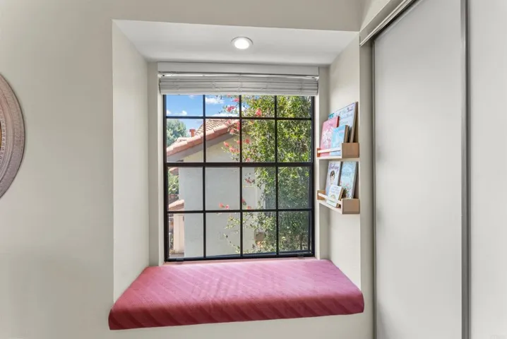 Charming built-in window seat provides the perfect reading nook with abundant natural light.