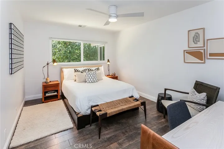 Two additional bedrooms enjoy treetop and hillside views, modern ceiling fans, and generous closet space.