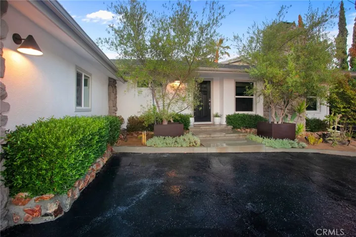 Beyond a long-gated driveway, the noise and pace of the city give way to a beautifully maintained single-story residence where privacy, picturesque hillside and canyon views, and thoughtfully designed indoor and outdoor living spaces create an atmosphere that is both peaceful and inviting. Surrounded by its natural hillside setting, the 2,295-square-foot residence was created for both relaxed everyday living and memorable entertaining.
