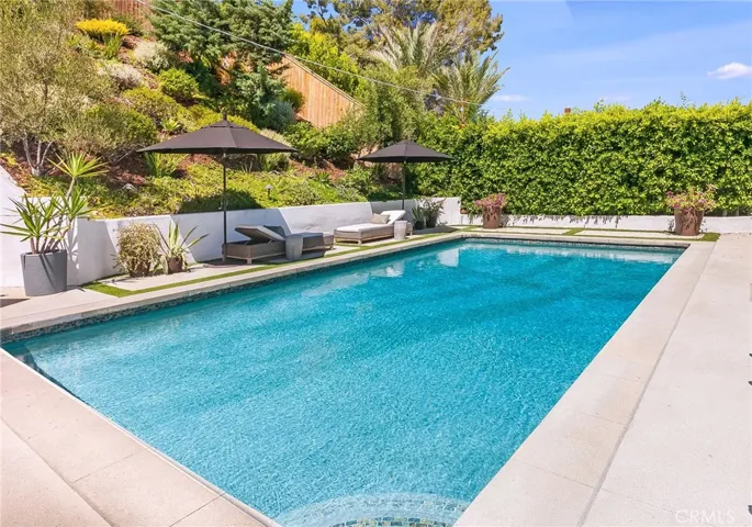 Multiple outdoor spaces, and the sparkling heated saltwater pool invite everything from lively weekend gatherings to quiet mornings with a cup of coffee. A gas fireplace, mature landscaping, newer smart-controlled pool equipment, and peaceful hillside surroundings provide inviting spaces to enjoy throughout the year.
