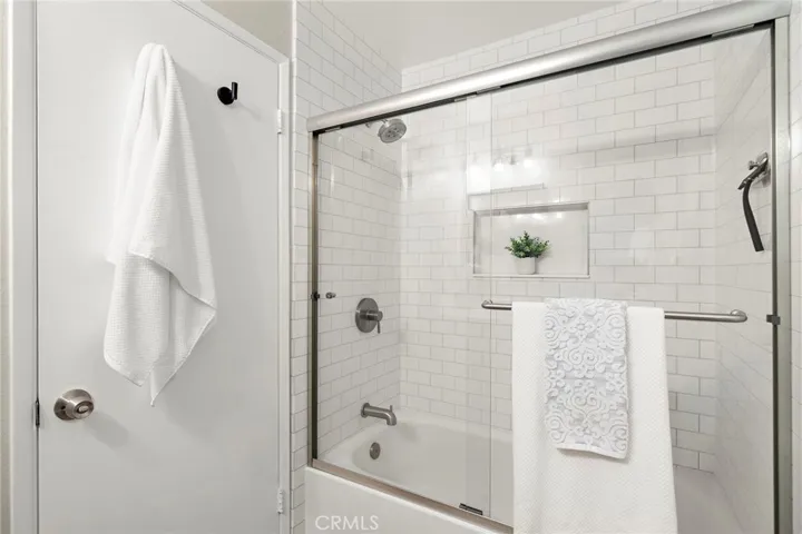 New floor to ceiling tile, bathtub and glass enclosure