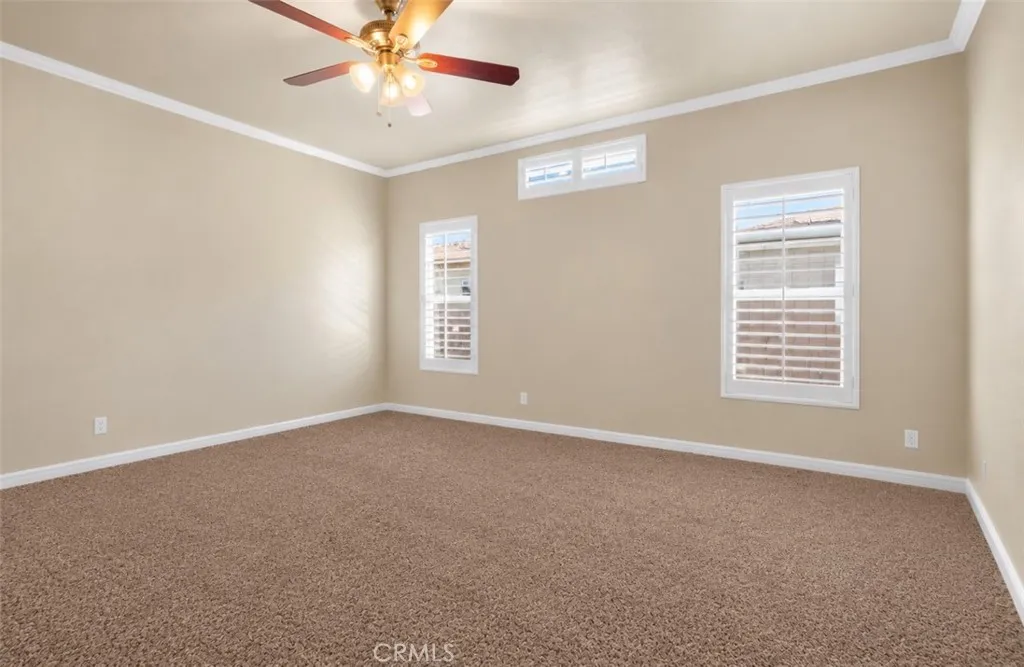 Virtually enhanced primary bedroom to reflect new carpet and removal of furnishings.