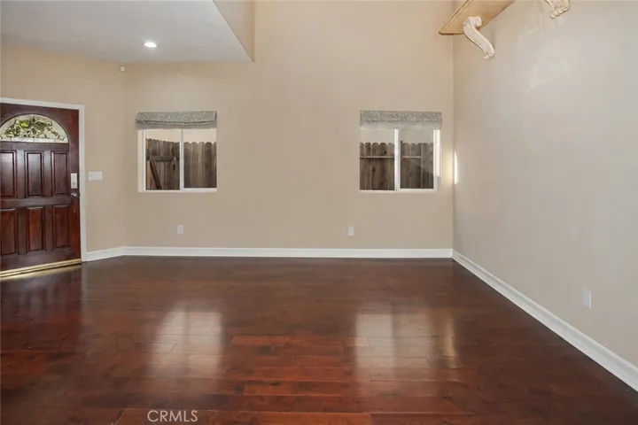 The formal living room offers a warm welcome for guests, while the adjacent dining room, highlighted by its elegant double tray ceiling, is equally suited for holiday celebrations, dinner parties, or everyday meals.