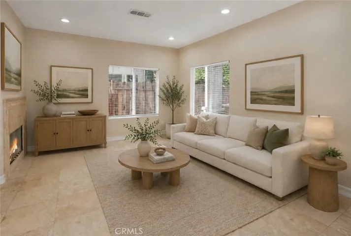 Photo is virtually staged.  Previous photo is how property currently shows. At the heart of the home, the oversized family room is where everyday life comes together. Centered around a cozy fireplace and open to the kitchen, it's easy to picture everything from movie nights and weekend football to quiet evenings spent together.