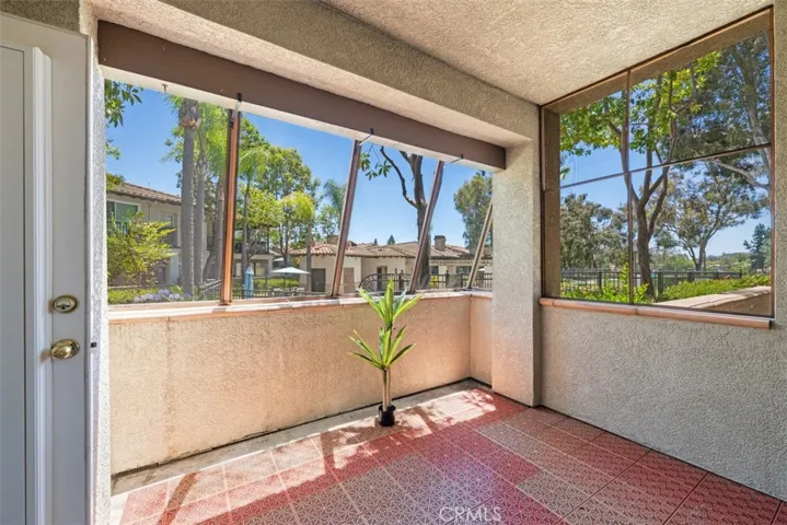 Patio with views of pool and golf course