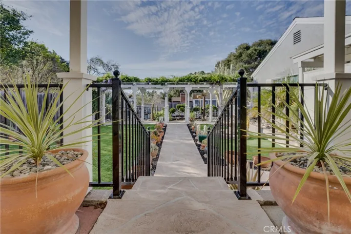 steps from patio toward a beautifully maintained yard.
