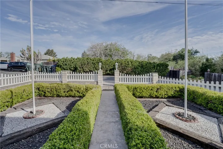 Path to front entry front yard and street to the left private drive in front, parcel I runs to the juniper/wood fence.