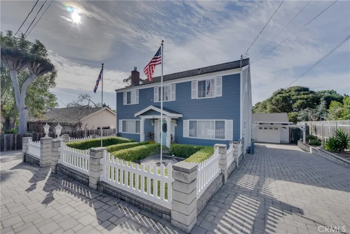 View showing numerous parking spaces on paved driveway on both sides of home.
