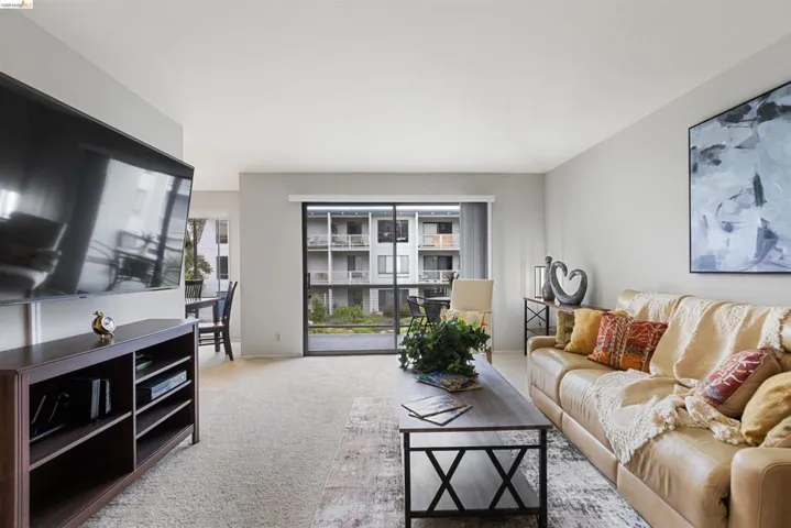 Living area featuring neutral wall tones and light-colored carpeting
