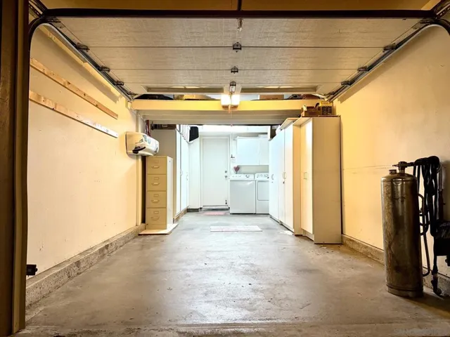1 car attached garage with storage cabinets. Washer & Dryer are also in the garage.