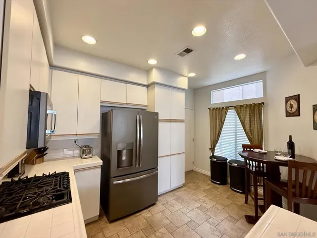 Kitchen includes lots of cabinets, space for a breakfast nook, and direct access to the garage (where laundry is located)