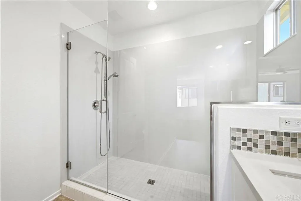 Spacious glass-enclosed shower with sleek, modern design.
