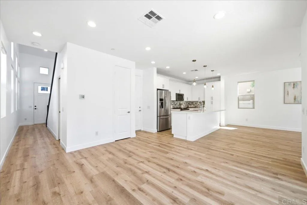 Spacious open-concept living and dining area with durable plank flooring.