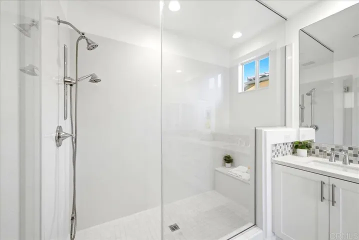 Walk-in shower with frameless glass enclosure and contemporary finishes.