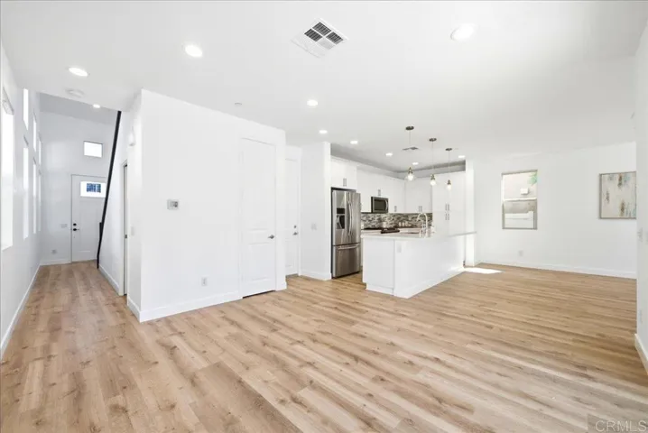 Spacious open-concept living and dining area with durable plank flooring.