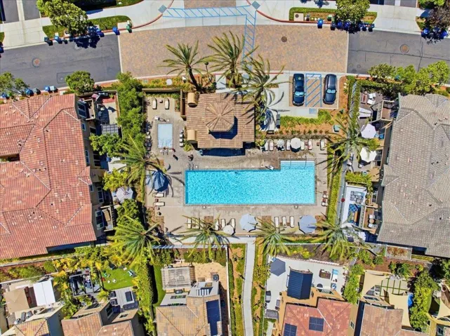 Bird's-eye view of the community pool, clubhouse, and landscaped grounds.