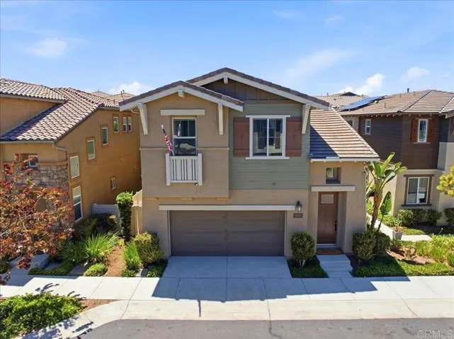 Modern two-story home with attractive curb appeal, a two-car garage, and landscaped entry.