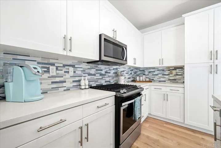 Bright kitchen with modern cabinetry, quartz counters, and ample prep space.