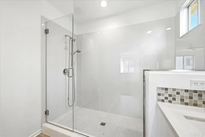Spacious glass-enclosed shower with sleek, modern design.