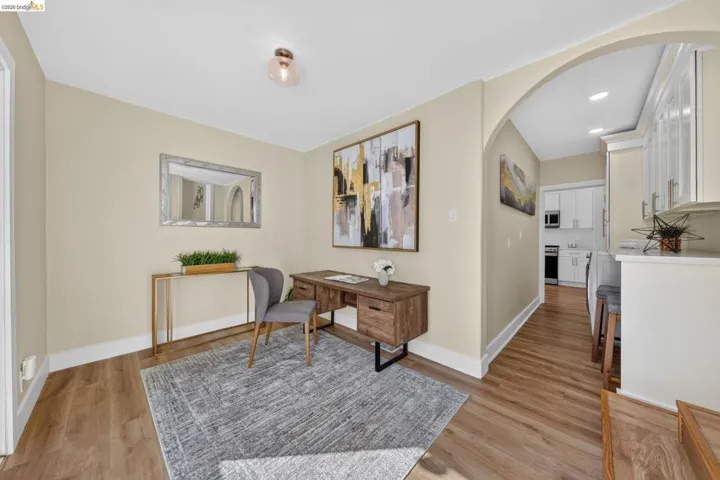 Versatile room featuring wood-finish flooring and an arched doorway