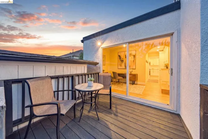 Outdoor deck featuring wood-finish flooring and a black railing