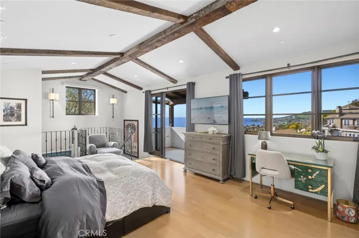 The primary suite serves as a private retreat, framed by multiple ocean-view windows and opening to a large covered balcony with mesmerizing views.