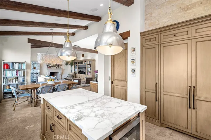 The living, dining, and kitchen areas are unified by abundant natural light and uninterrupted ocean vistas, creating an inviting setting for everyday living and memorable occasions alike.