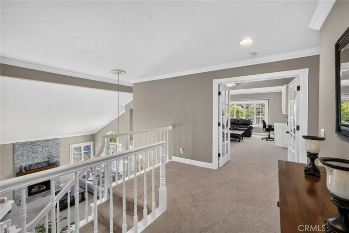 Leaving main bedroom overlooking first level and expansive bonus room
