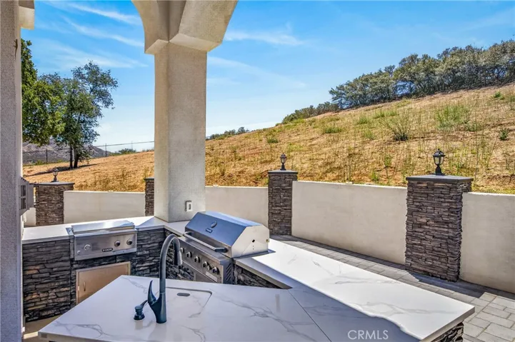 Outdoor built in kitchen with sink and 2 grills