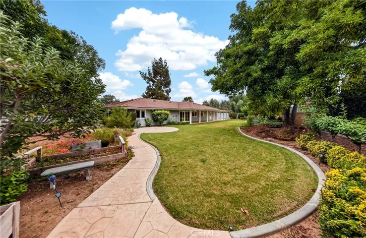 Many mature fruit trees, including lemon, orange and a HUGE avocado tree. Several raised garden beds.