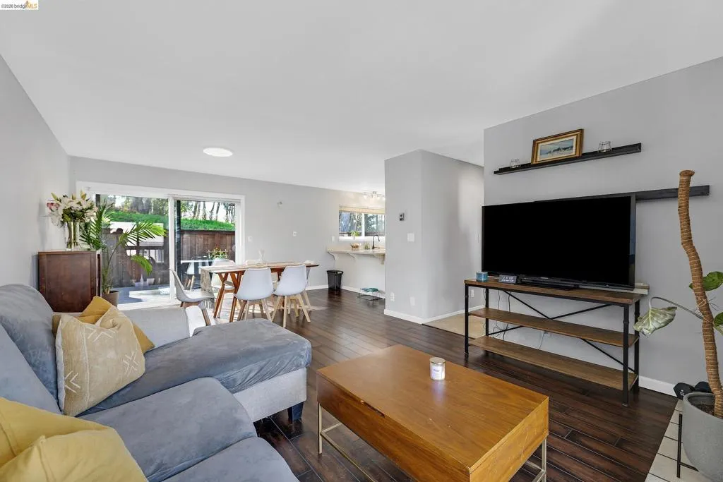 Living room featuring hardwood / wood-style floors and baseboards