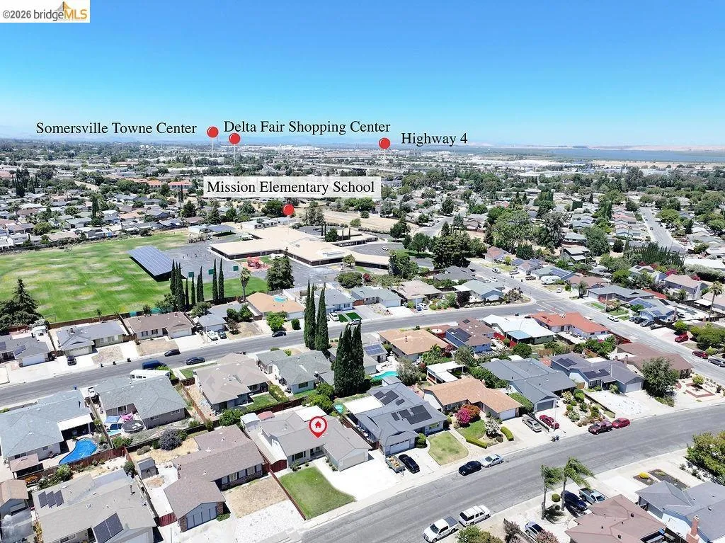 Aerial perspective of a residential community featuring single-family homes with diverse rooflines and landscaping